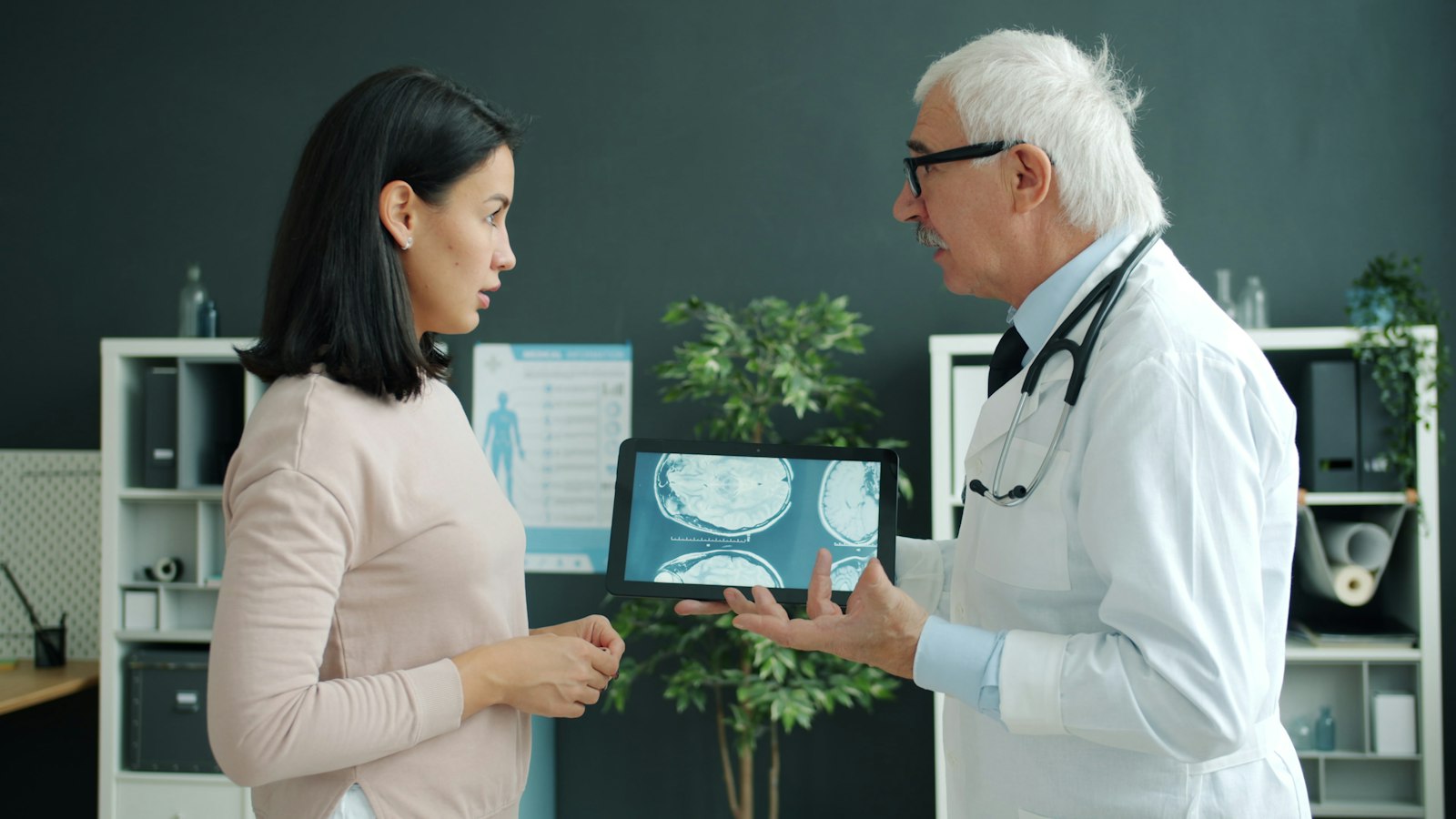 Clinician reviewing patient data on a tablet with a patient